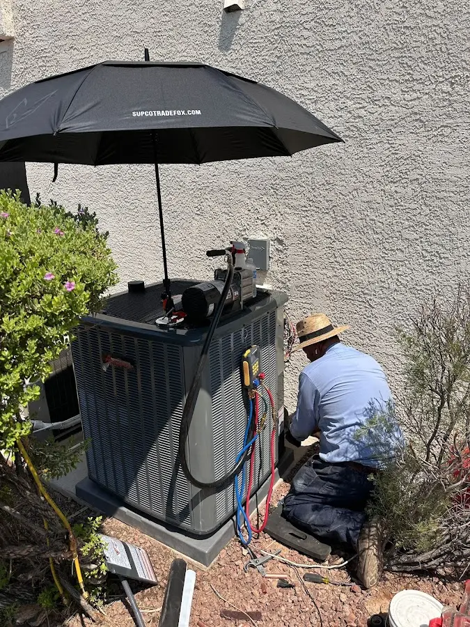 HVAC technician performing outdoor AC maintenance in Parkersburg